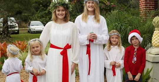 Two ladies, three little girls and a little boy dressed up for Christmas